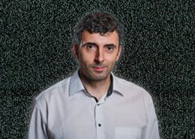 Image of a man wearing a white shirt, black hair 